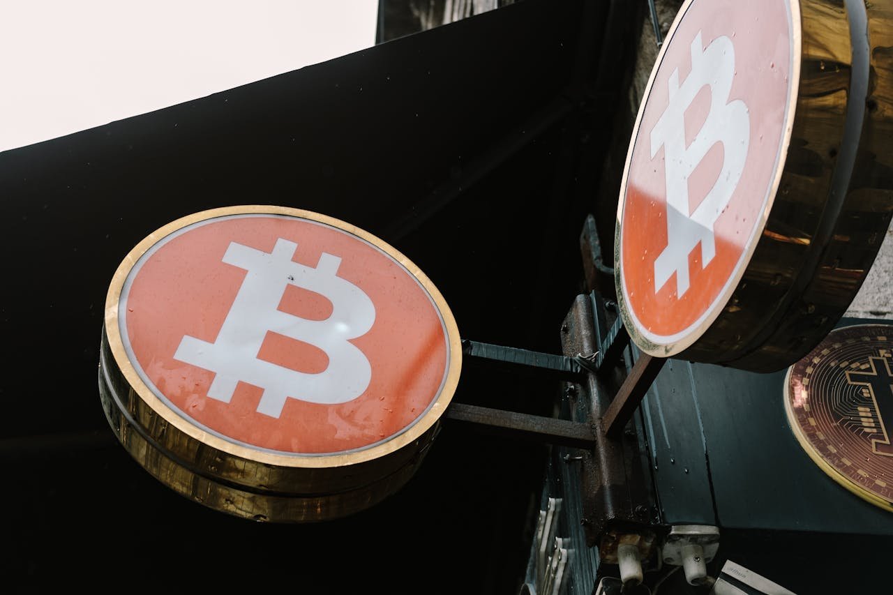 Close-up view of outdoor bitcoin symbol signs, reflecting modern cryptocurrency trends.